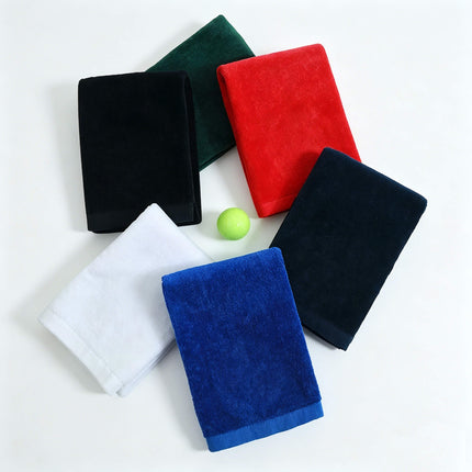 Eliteshine MH-F cotton golf towel in six colours — black, navy, green, red, white, and blue — rolled and stacked with karabiner clip visible on white background