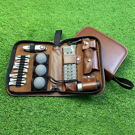 Angled lifestyle view of Eliteshine W01 golf pouch on grass showing closed brown PU leather exterior with wrist strap and zipper detail