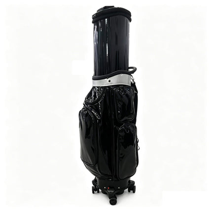 Eliteshine golf travel bag in black crystal PU with tan leather accents, swivel wheels and retractable height — side view