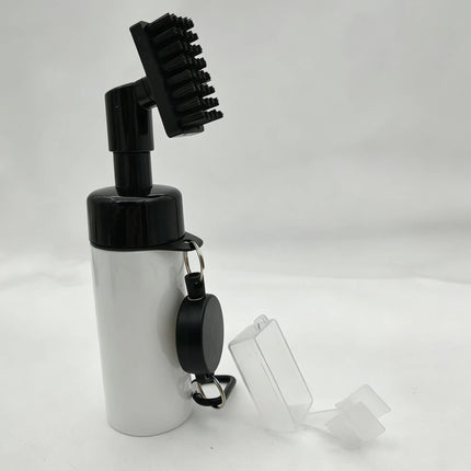 Rear view of Eliteshine F01 golf brush in white showing groove cleaner head tilted open and retractable carabiner cord reel on bottle