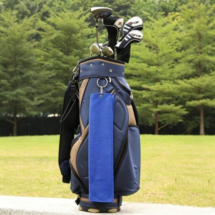Eliteshine golf towel clipped to navy golf bag on course — waffle cotton trifold towel with carabiner attachment