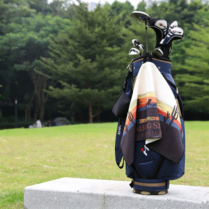 Eliteshine MH-B custom print golf towel draped over navy golf bag on course — vibrant digital print design with trifold layout