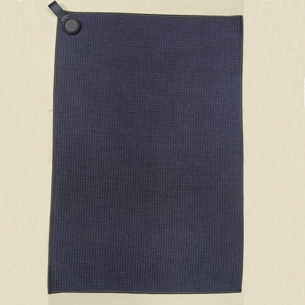 Eliteshine MH-E diagonal pocket golf towel in black rectangular format — 420/450gsm waffle cotton with magnetic button, karabiner clip, and ribbon loop on wooden surface