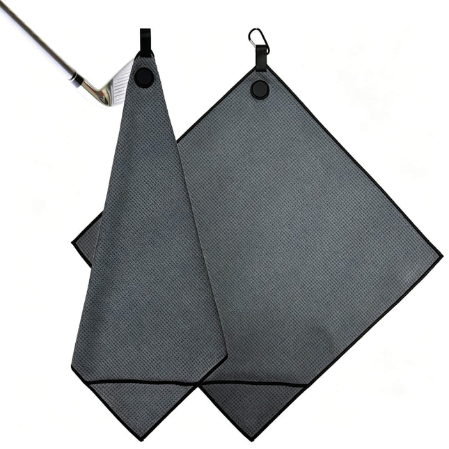 Eliteshine MH-E diagonal pocket golf towel in grey square format — laid flat on wooden surface with magnetic button, karabiner clip, and ribbon loop at top edge, the magnet clips it tightly with the club
